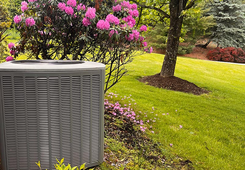 An outdoor air conditioning unit overlooks the lawn.
